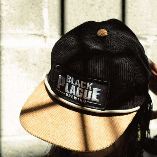 Black corduroy hat with a tan corduroy brim, rope and a BLACK PLAGUE Brewing patch