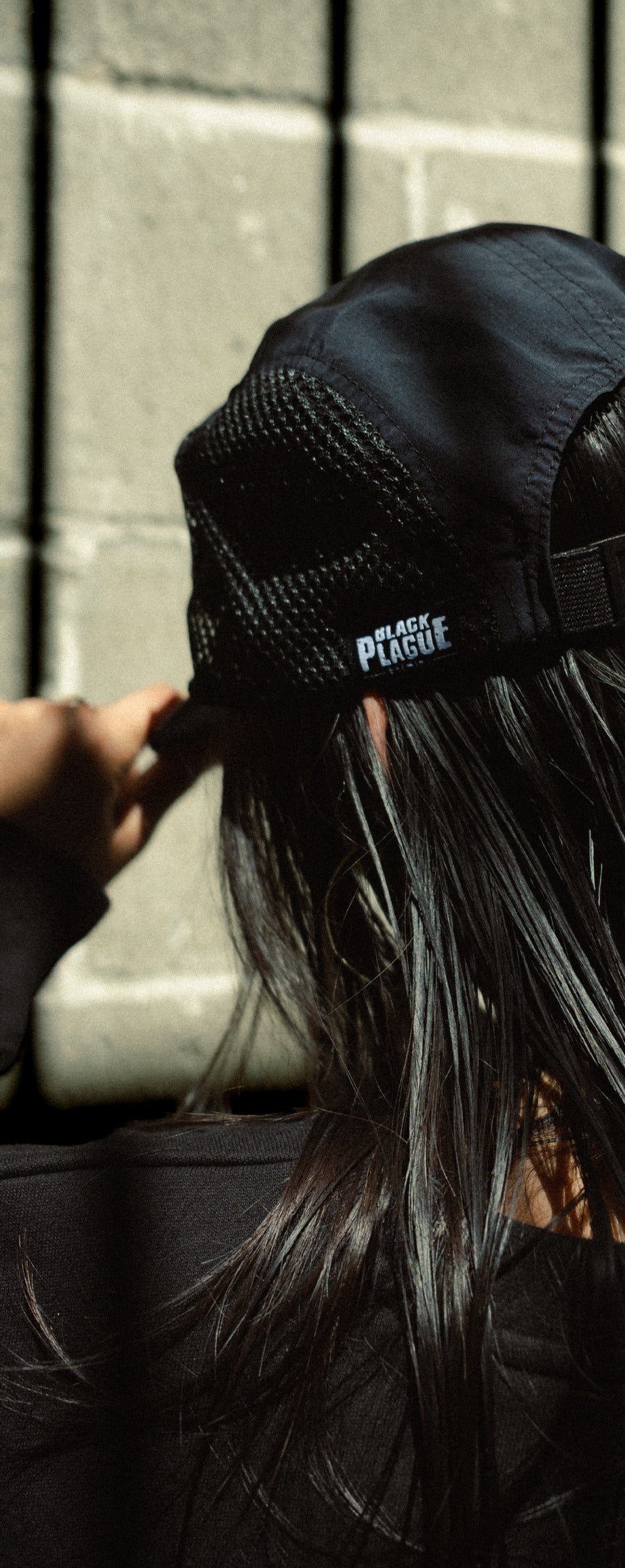 Black mesh camp hat worn, seen from behind