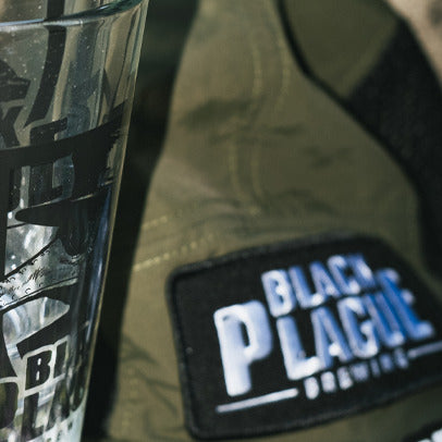 Olive camp hat with a BLACK PLAGUE Brewing patch