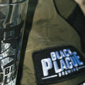 Olive camp hat with a BLACK PLAGUE Brewing patch